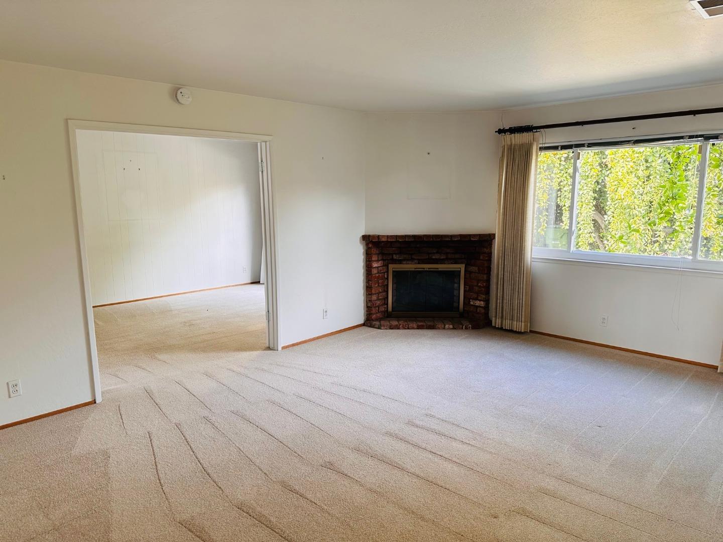 941 Springfield Drive Campbell, CA 95008 - Photo 4 of 22 an empty room with windows and a fireplace