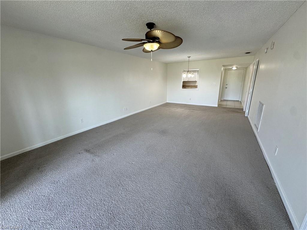 5667 Rattlesnake Hamm Road North, Unit B301 Naples, FL 34113 - Photo 3 of 17 a view of empty room with windows