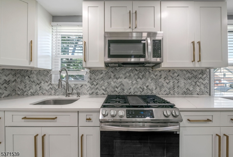 47 Ekings Avenue Hawthorne, NJ 07506 - Photo 2 of 12 a sink stove sitting inside of a kitchen