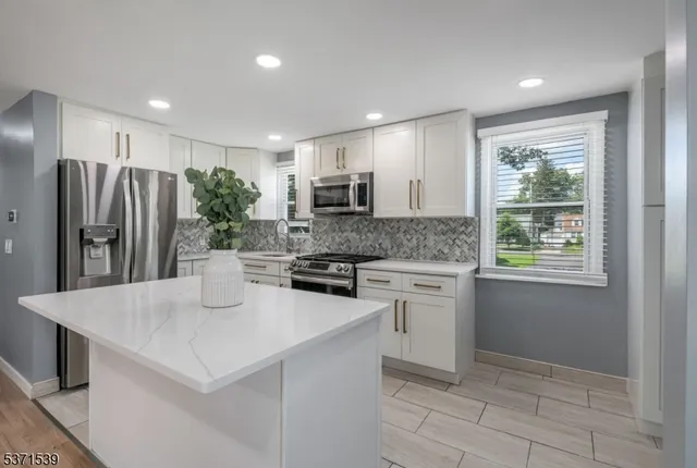 a kitchen with a refrigerator and a sink