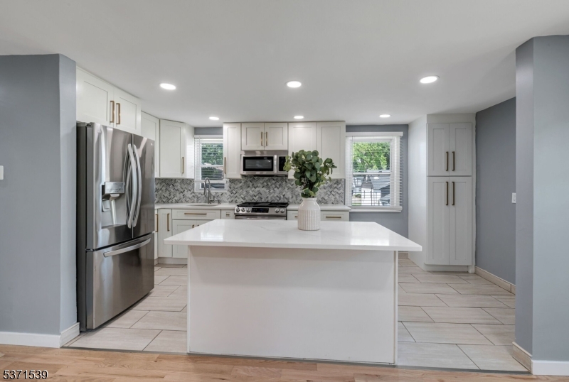 47 Ekings Avenue Hawthorne, NJ 07506 - Photo 5 of 12 a kitchen with stainless steel appliances a refrigerator sink and stove