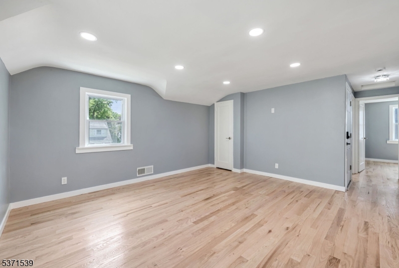 47 Ekings Avenue Hawthorne, NJ 07506 - Photo 9 of 12 a view of an empty room with wooden floor and a window