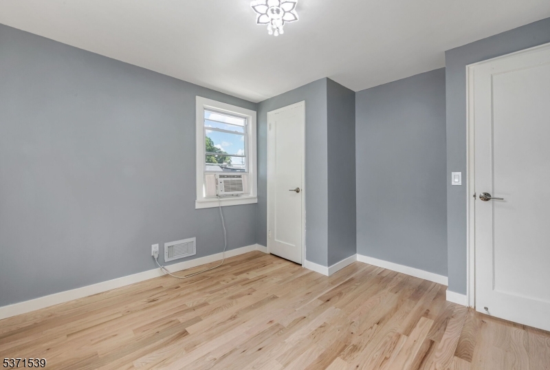 47 Ekings Avenue Hawthorne, NJ 07506 - Photo 10 of 12 a view of wooden floor and windows in a room
