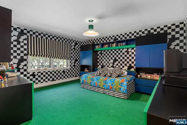 a bedroom with a large bed and a dresser