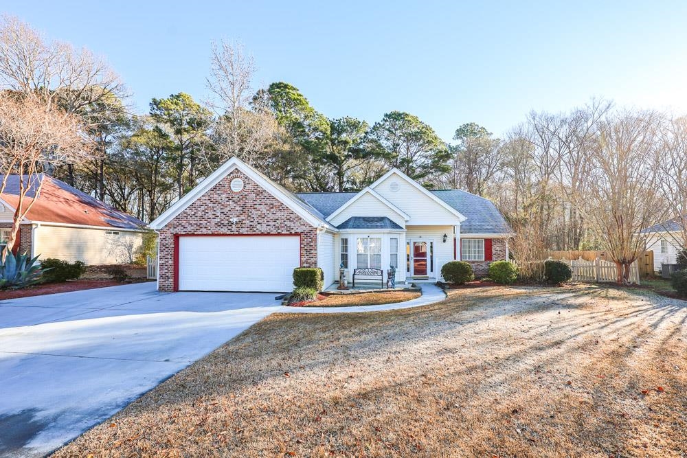 Ranch-style house featuring driveway, brick siding, and a garage
