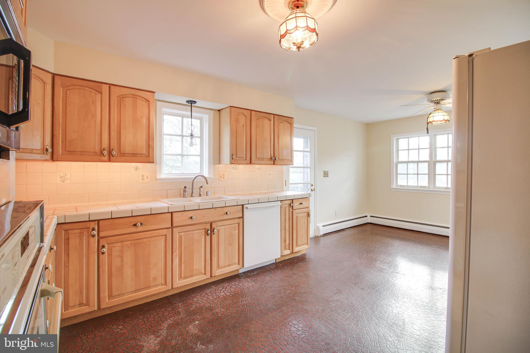 14 Overhill Road Catonsville, MD 21228 - Photo 14 of 38 a view of a kitchen with a sink dishwasher cabinets and a window