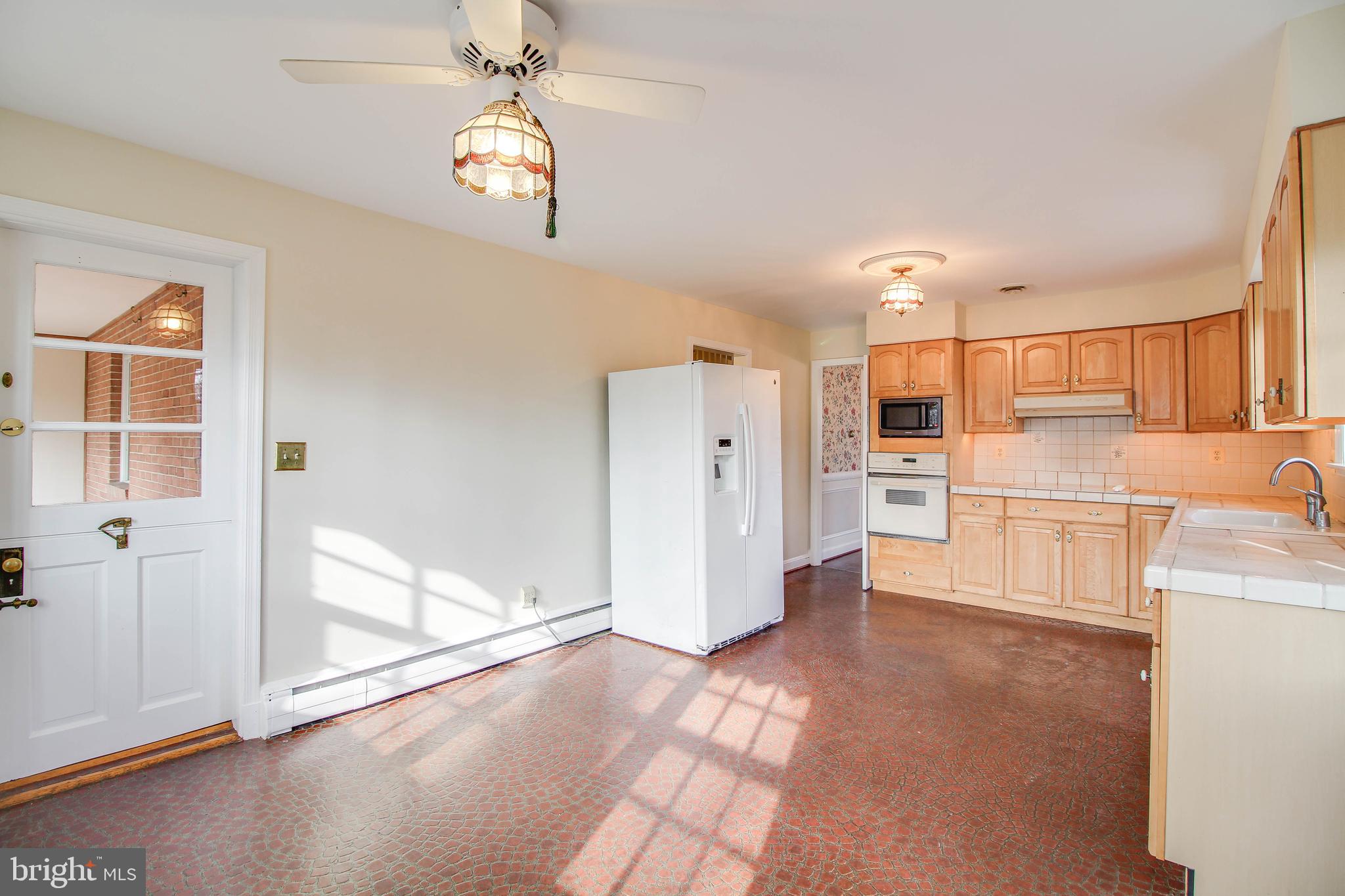 14 Overhill Road Catonsville, MD 21228 - Photo 15 of 38 a view of a kitchen with wooden floor and a refrigerator
