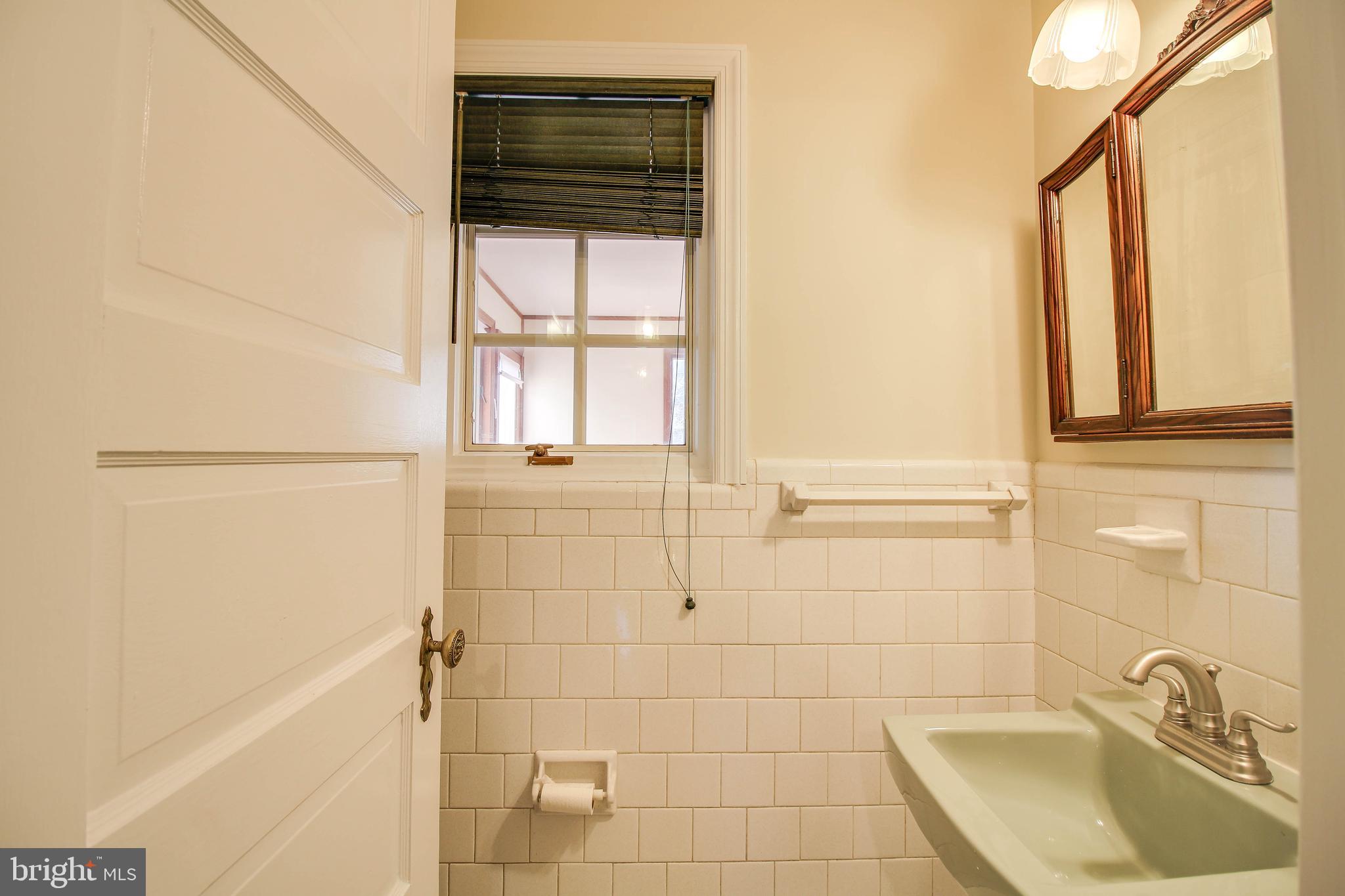 14 Overhill Road Catonsville, MD 21228 - Photo 16 of 38 a bathroom with a sink a bathtub and next to a window