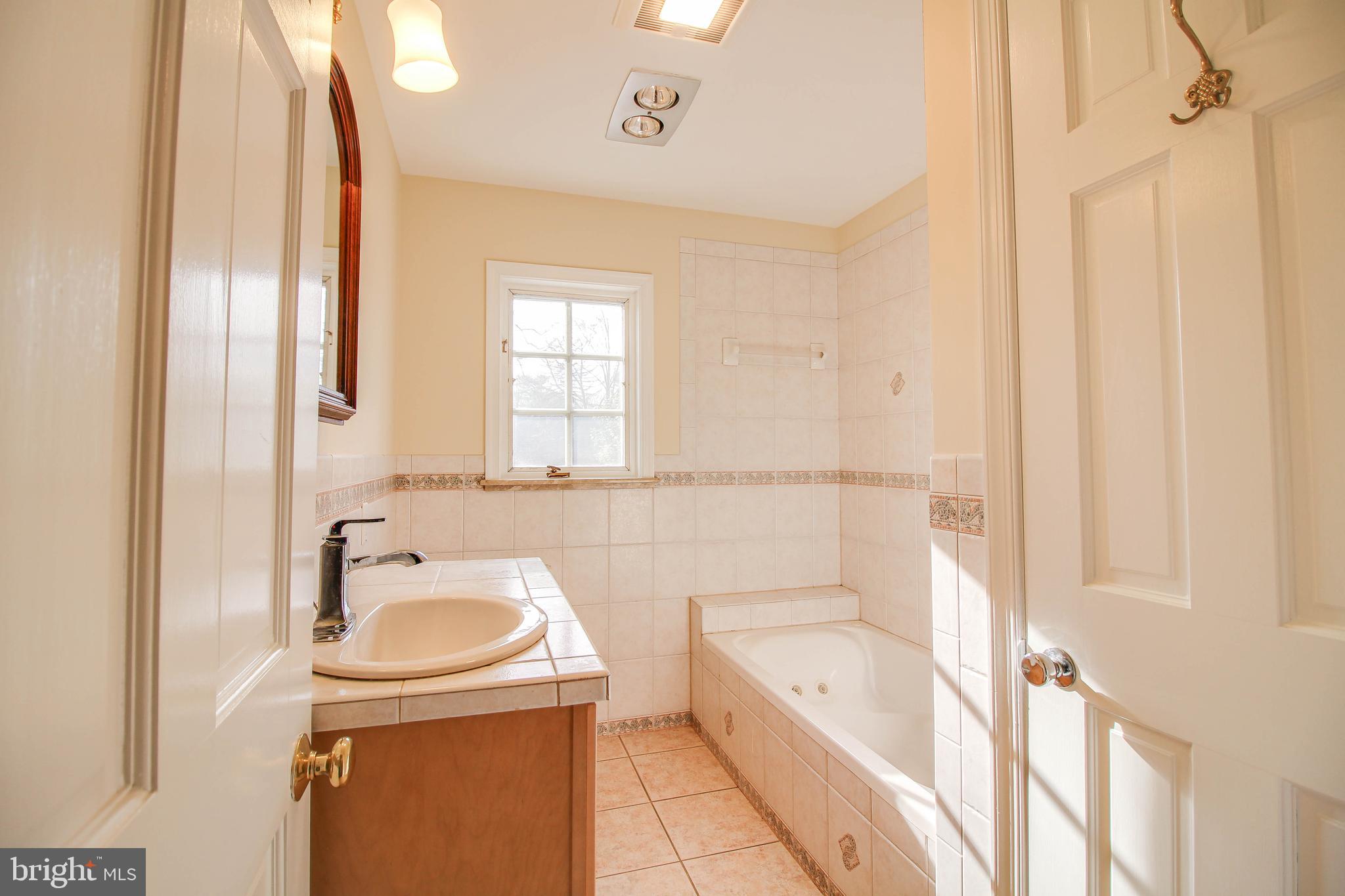 14 Overhill Road Catonsville, MD 21228 - Photo 24 of 38 a bathroom with a tub sink and mirror