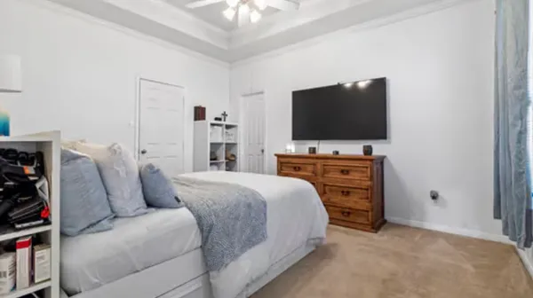 a bedroom with a bed and a flat screen tv