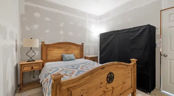 a bedroom with a bed and a table