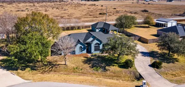 an aerial view of a house with a yard