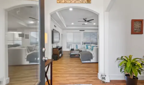 a living room with furniture and a chandelier