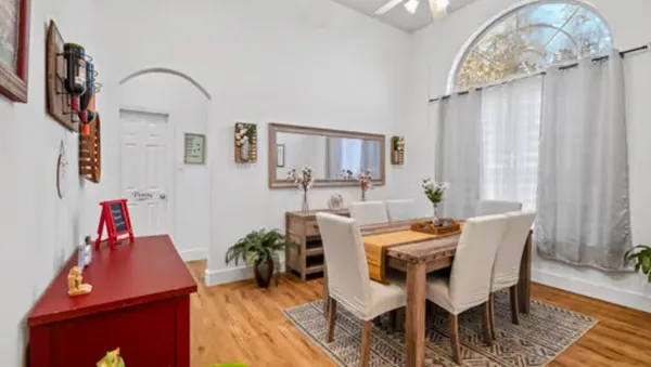 a dining room with furniture and window