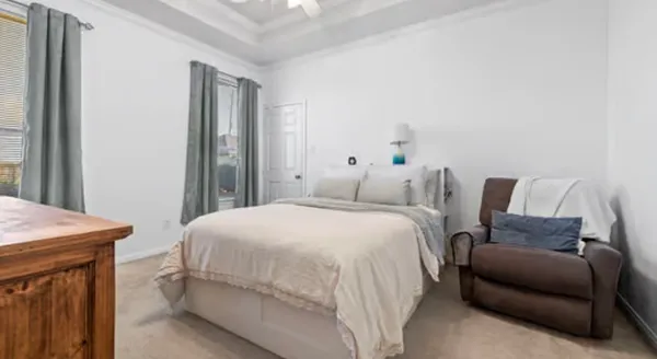 a bedroom with a bed and a dresser