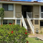 a front view of a house with plants