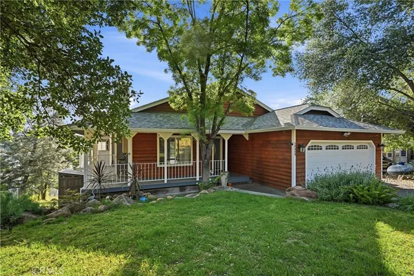 a front view of house with yard and green space