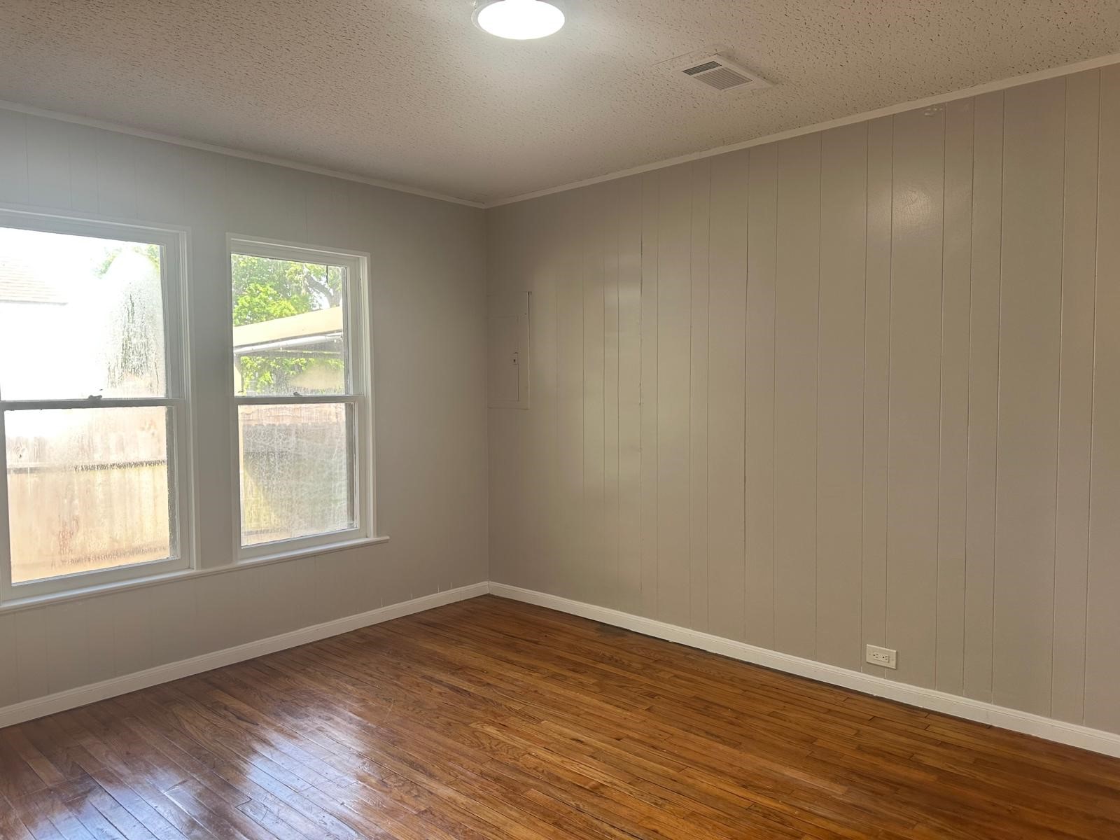 918 West 5th Street, Unit 1 Freeport, TX 77541 - Photo 14 of 21 an empty room with wooden floor and windows