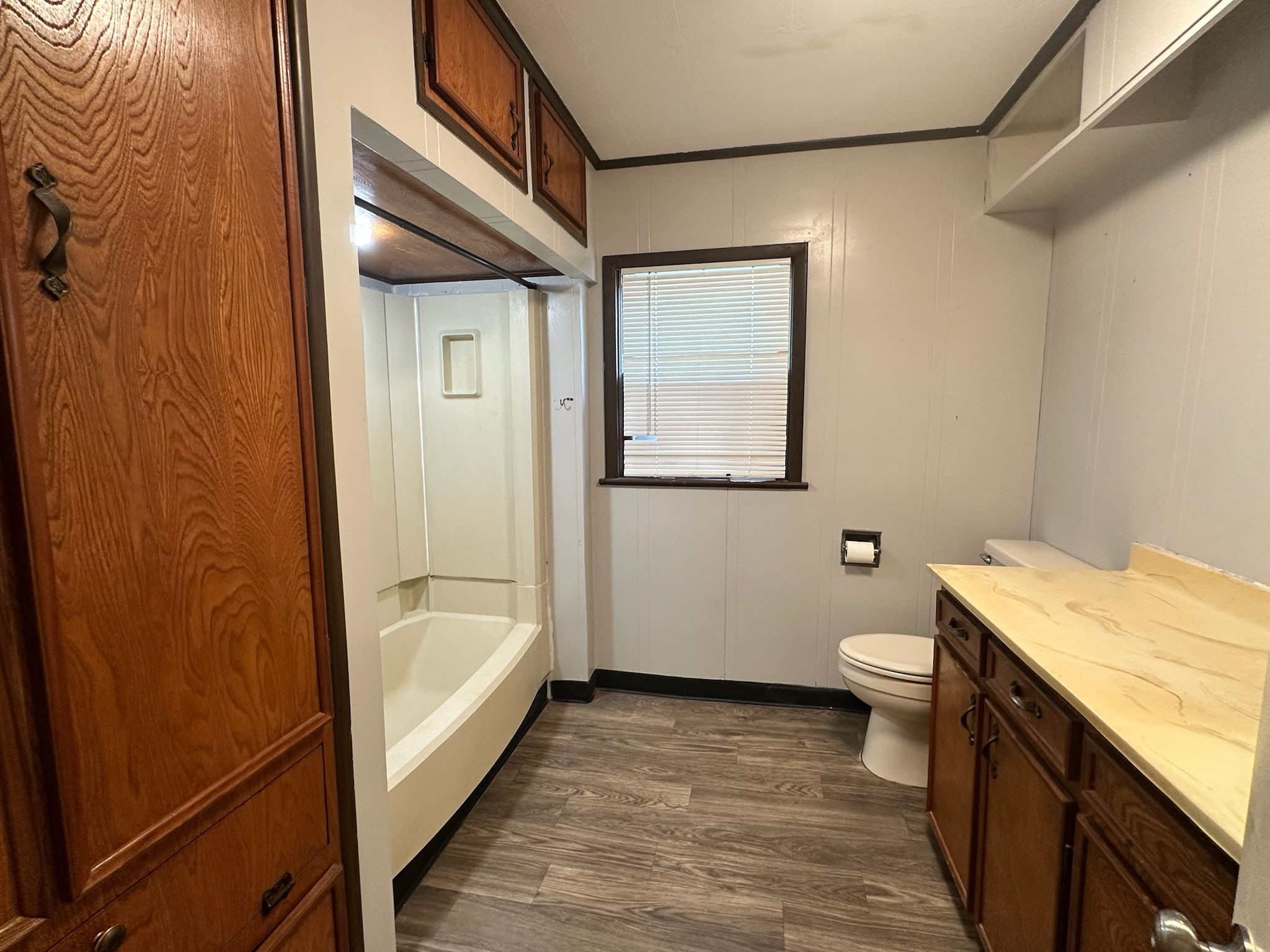 918 West 5th Street, Unit 1 Freeport, TX 77541 - Photo 16 of 21 a bathroom with a granite countertop bathtub sink vanity mirror and toilet
