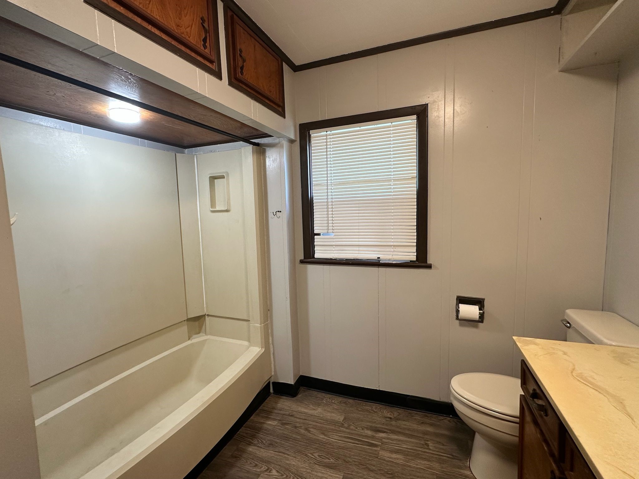 918 West 5th Street, Unit 1 Freeport, TX 77541 - Photo 17 of 21 a bathroom with a granite countertop toilet a sink and bathtub