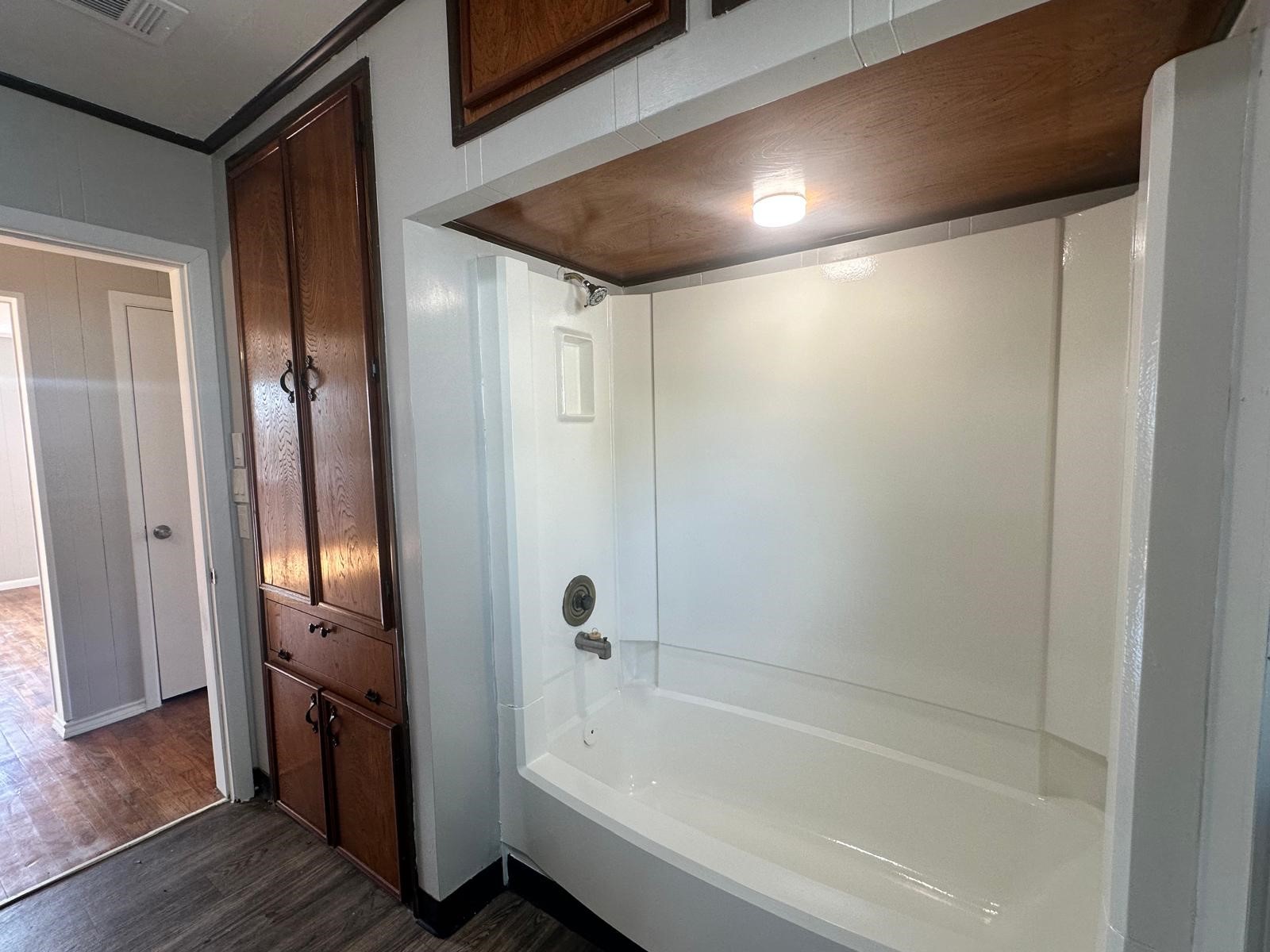 918 West 5th Street, Unit 1 Freeport, TX 77541 - Photo 18 of 21 a bathroom with a bathtub and a shower