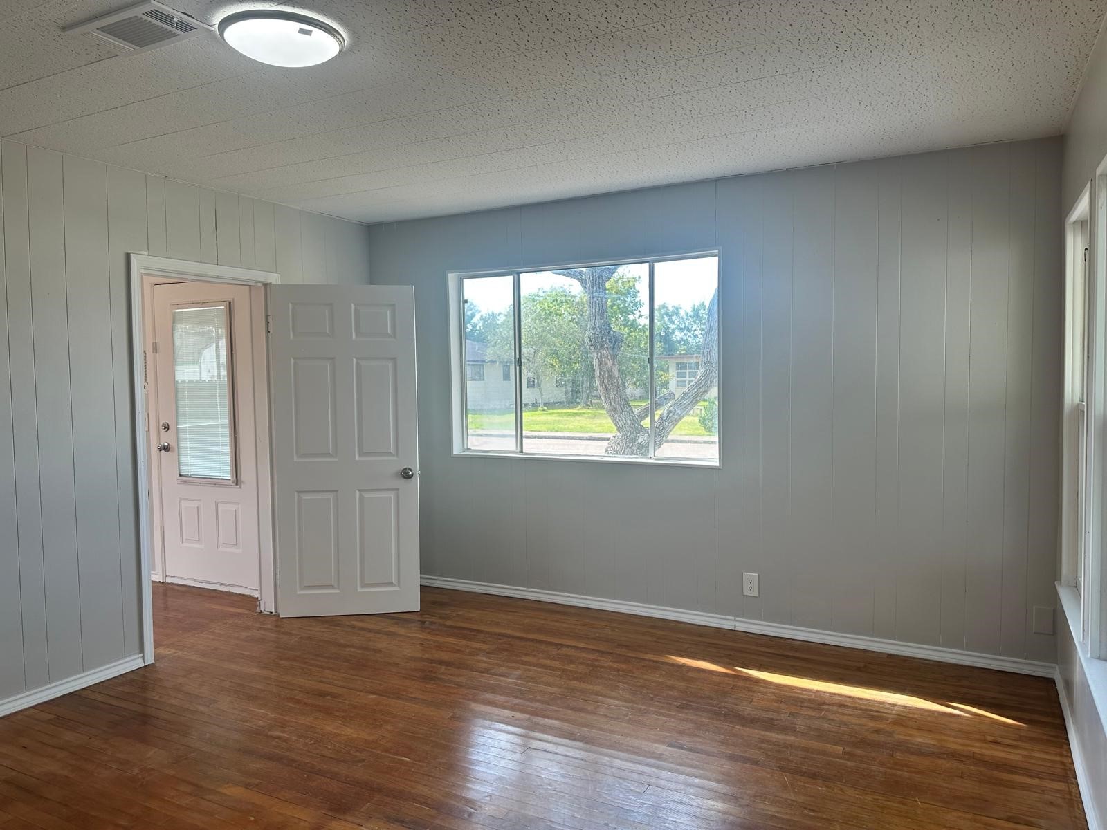 918 West 5th Street, Unit 1 Freeport, TX 77541 - Photo 20 of 21 a view of an empty room with wooden floor and a window