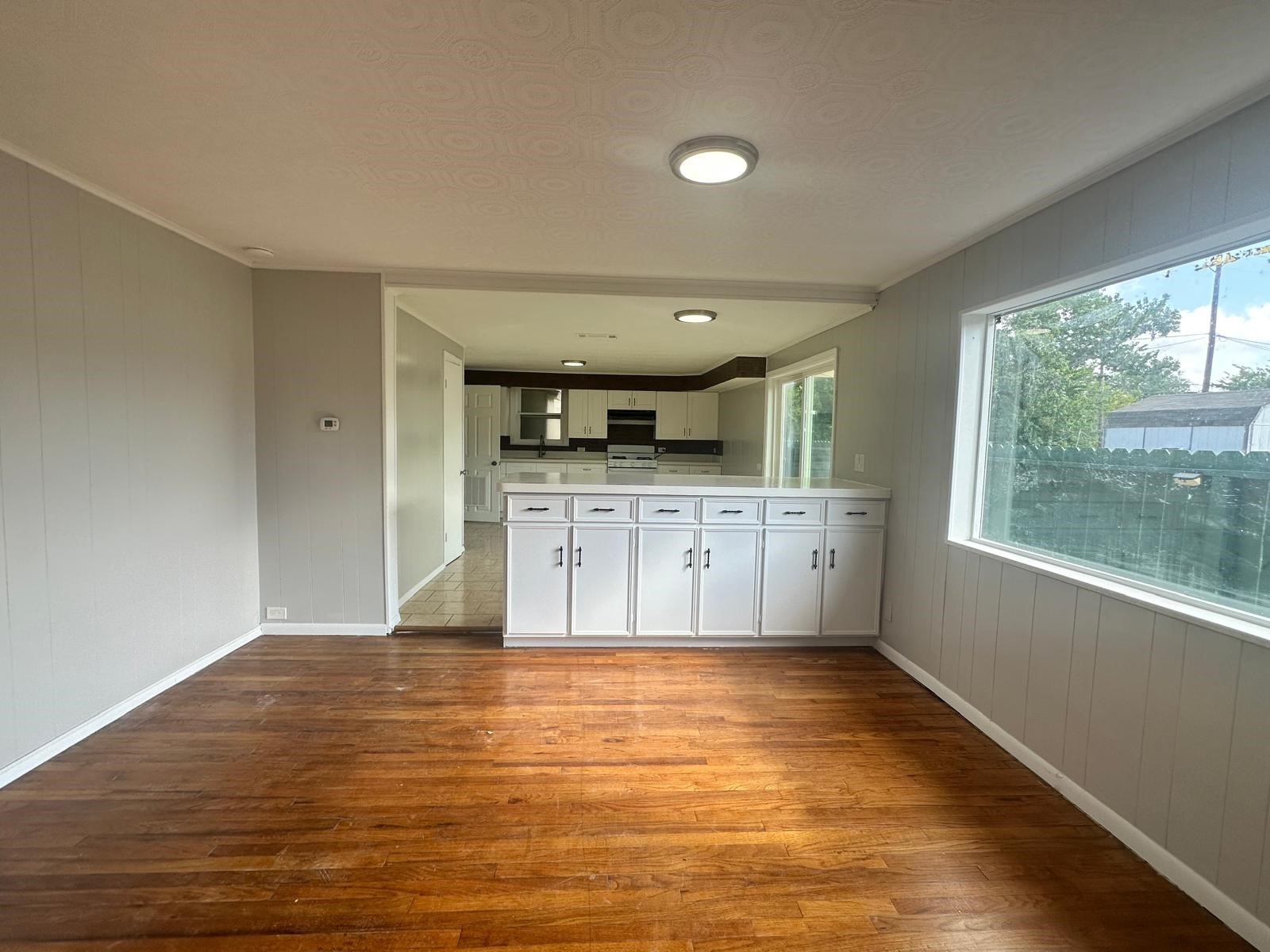 918 West 5th Street, Unit 1 Freeport, TX 77541 - Photo 6 of 21 a view of a kitchen with a sink hardwood vanity and a large window