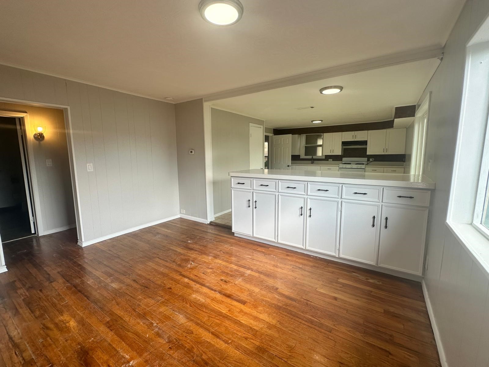 918 West 5th Street, Unit 1 Freeport, TX 77541 - Photo 7 of 21 a kitchen with granite countertop a sink and cabinets