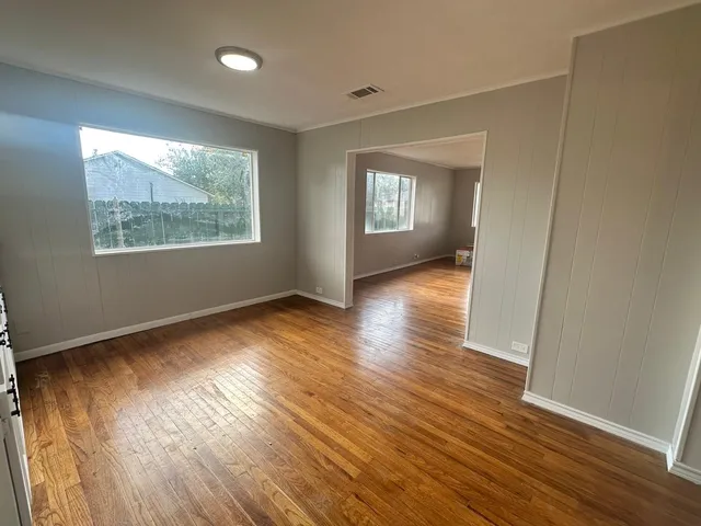 a living room with stainless steel appliances kitchen island granite countertop a sink and a stove top oven