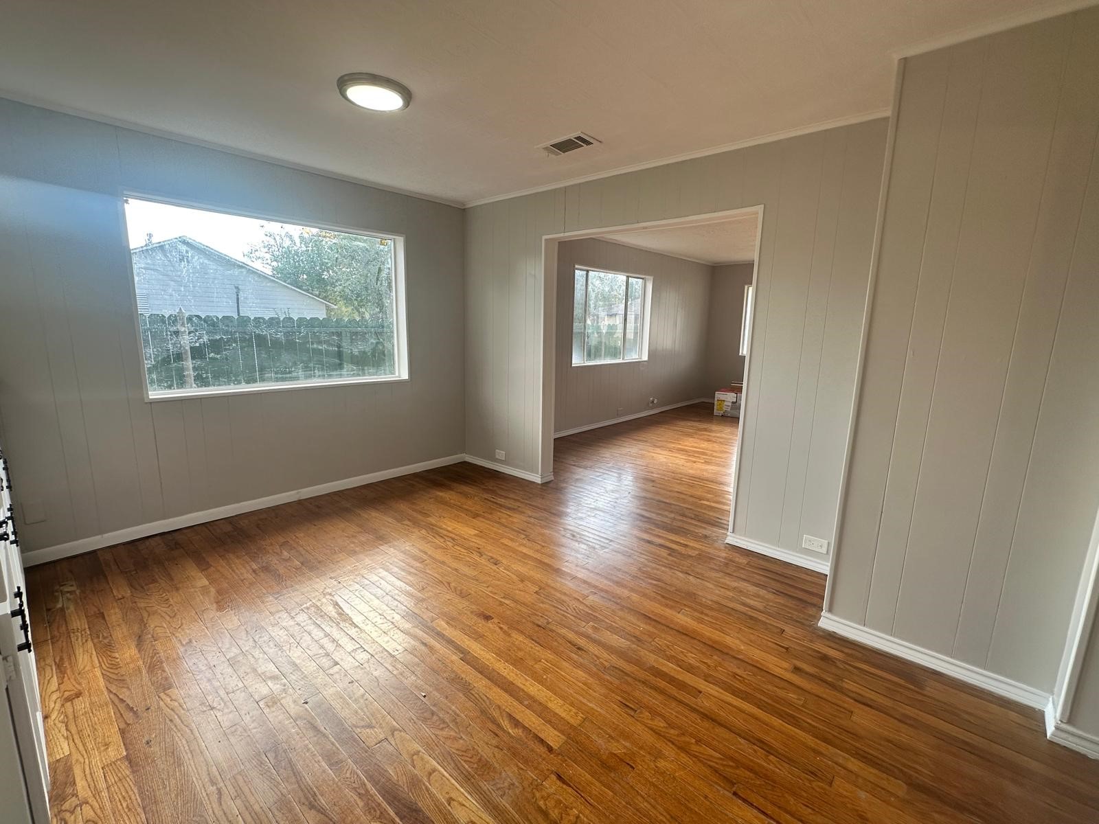 918 West 5th Street, Unit 1 Freeport, TX 77541 - Photo 8 of 21 an empty room with wooden floor and windows