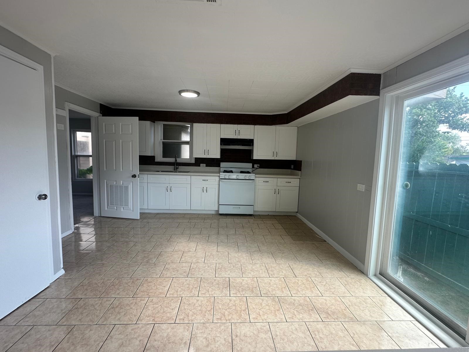 918 West 5th Street, Unit 1 Freeport, TX 77541 - Photo 9 of 21 a kitchen with stainless steel appliances granite countertop a refrigerator and a sink