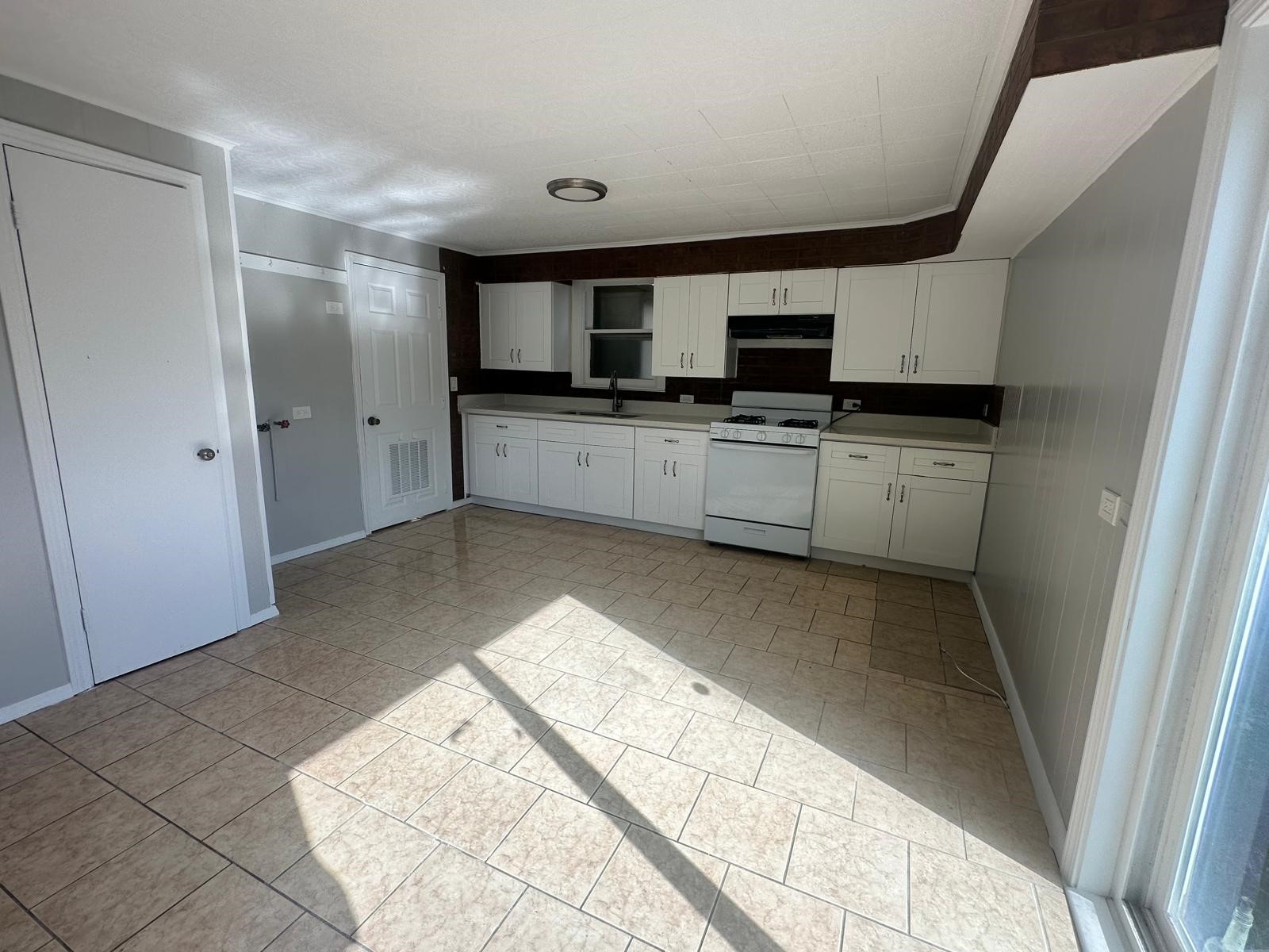 918 West 5th Street, Unit 1 Freeport, TX 77541 - Photo 10 of 21 a living room with stainless steel appliances kitchen island granite countertop a sink and a stove top oven