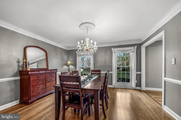 a kitchen with kitchen island a dining table and chairs