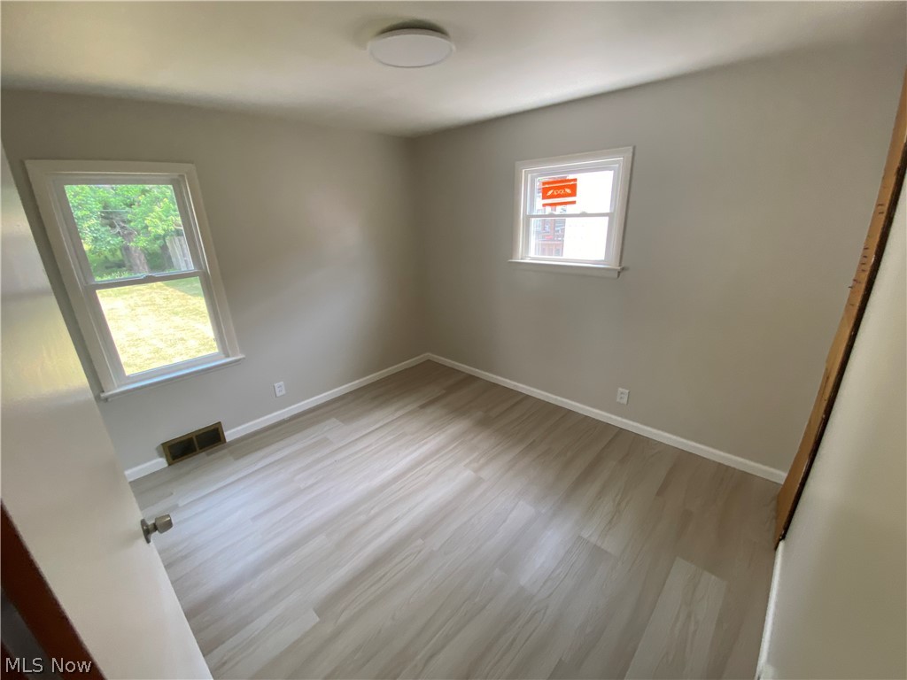 13117 Silver Road Garfield Heights, OH 44125 - Photo 12 of 20 Unfurnished room with a wealth of natural light and hardwood / wood-style flooring