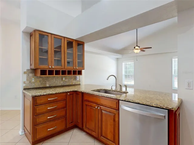 a bathroom with a granite countertop sink a mirror and vanity
