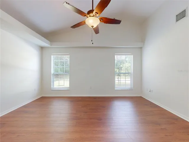 a view of a house with a backyard and a tree