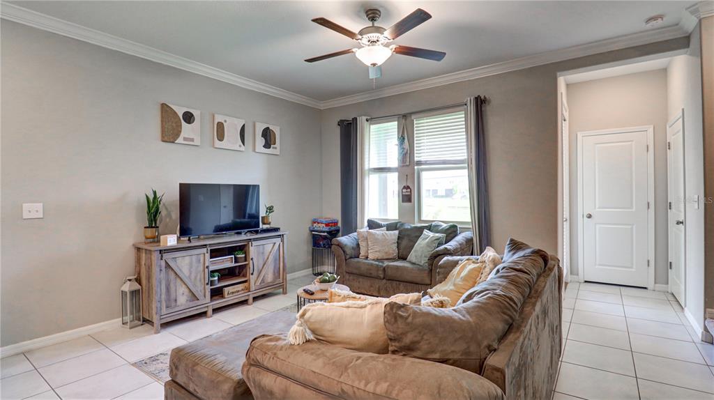 31632 Blue Passing Loop Wesley Chapel, FL 33545 - Photo 17 of 48 a living room with furniture and a flat screen tv