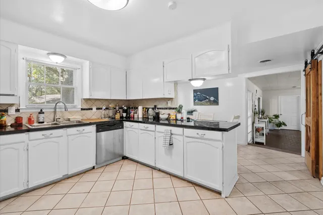 a kitchen with stainless steel appliances granite countertop a sink and cabinets