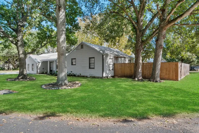 a front view of house with a garden