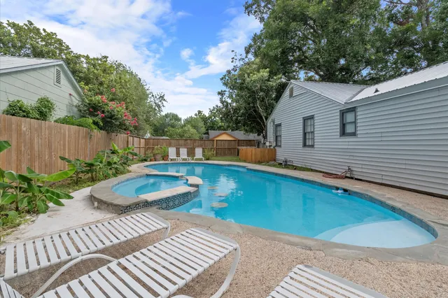 a view of a backyard with plants and a patio