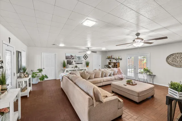 a living room with furniture and a chandelier