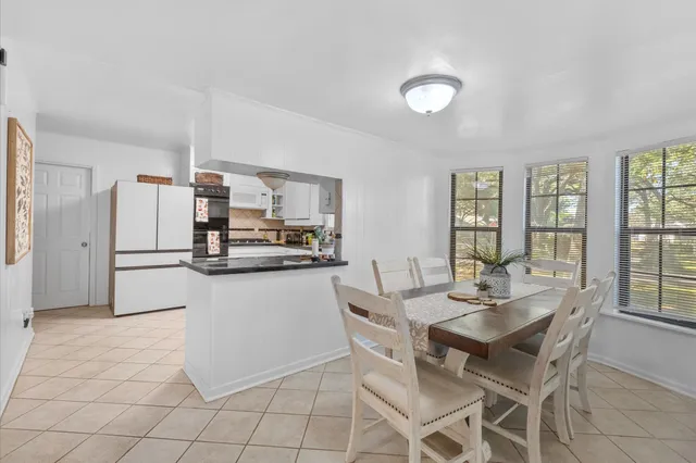 a kitchen with granite countertop refrigerator and cabinets