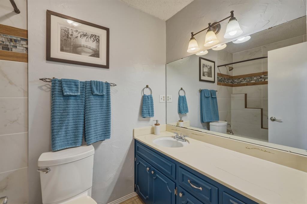 10203 Crestview Drive Tyler, TX 75707 - Photo 14 of 25 a bathroom with a sink a toilet and a mirror
