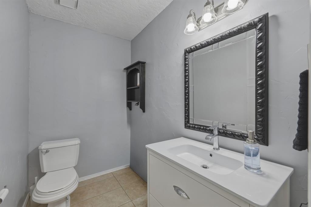 10203 Crestview Drive Tyler, TX 75707 - Photo 17 of 25 a bathroom with a sink toilet and mirror