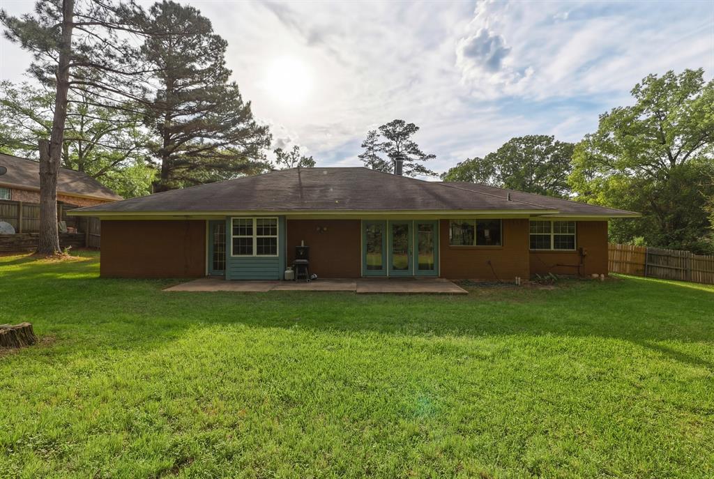 10203 Crestview Drive Tyler, TX 75707 - Photo 20 of 25 a front view of a house with a garden