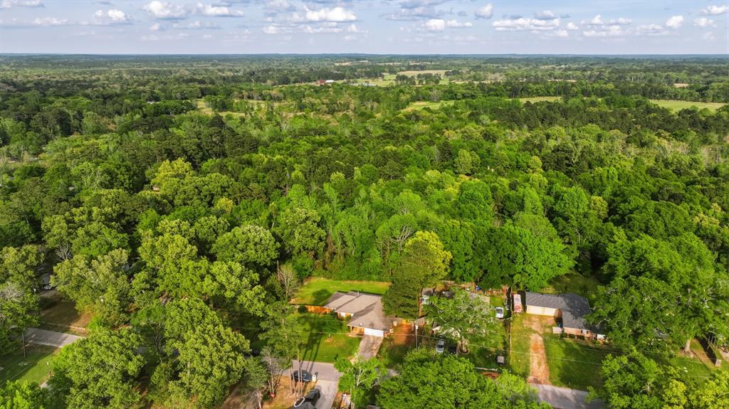 10203 Crestview Drive Tyler, TX 75707 - Photo 24 of 25 a view of a big yard with a building in the background