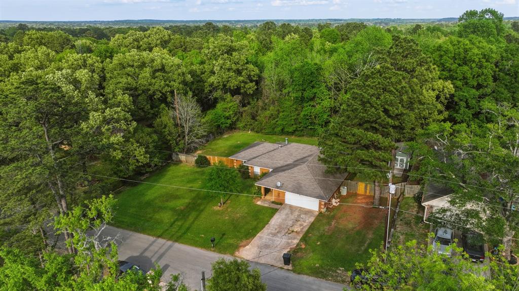 10203 Crestview Drive Tyler, TX 75707 - Photo 4 of 25 a view of a garden with a building in the background