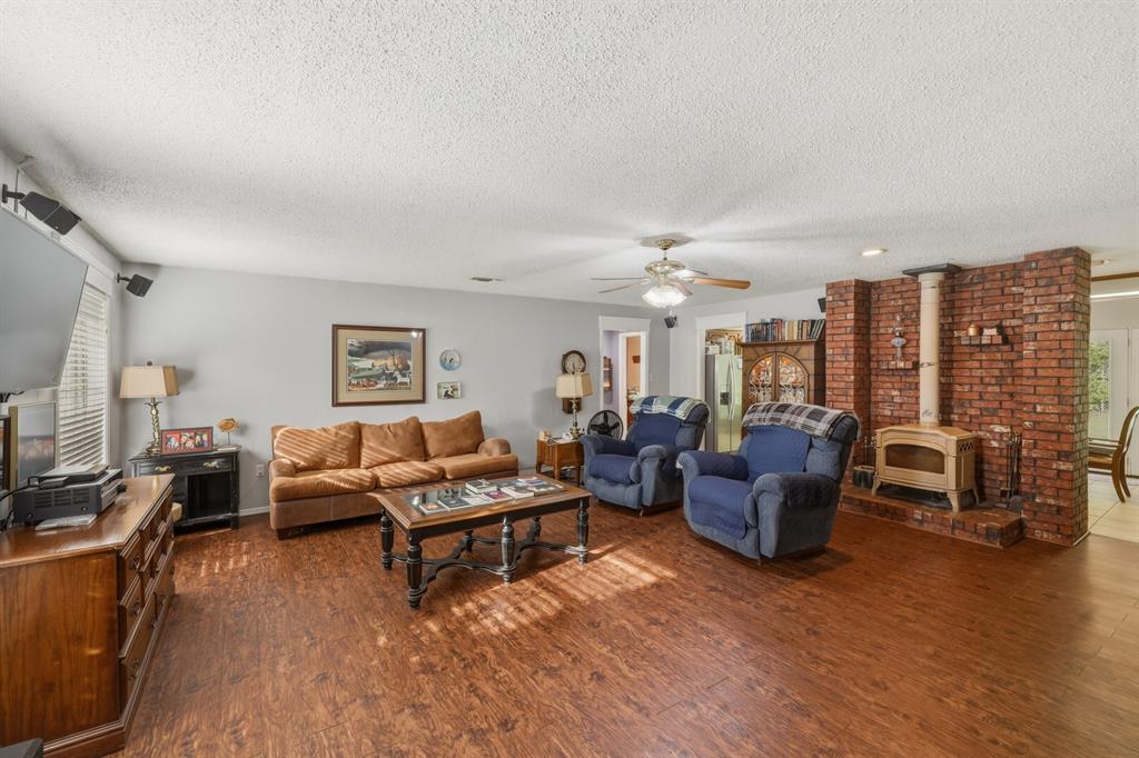 10203 Crestview Drive Tyler, TX 75707 - Photo 5 of 25 a living room with fireplace furniture and a wooden floor