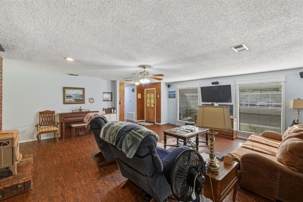 10203 Crestview Drive Tyler, TX 75707 - Photo 6 of 25 a living room with furniture a flat screen tv and couches