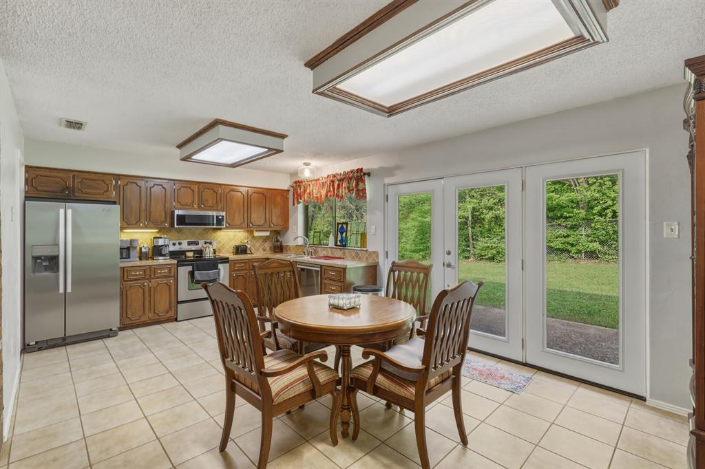 10203 Crestview Drive Tyler, TX 75707 - Photo 8 of 25 a dining room with furniture and a large window